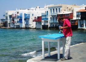 Man Painting Blue Door Mykonos Greece