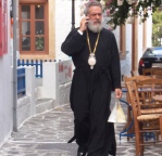 Priest with mobile phone Milos Greece